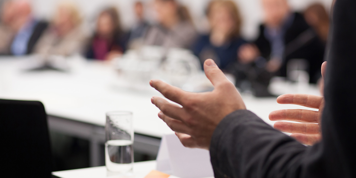 Closeup of presenter's hand at a seminar