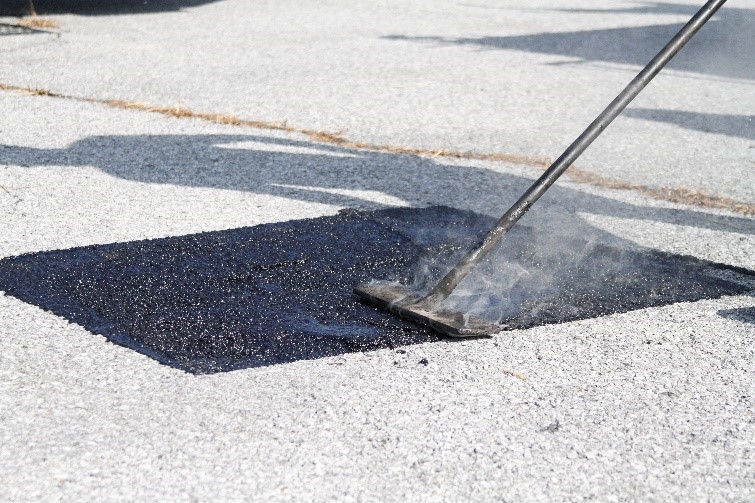 Hot Pour Mastics patch being applied to roadway.