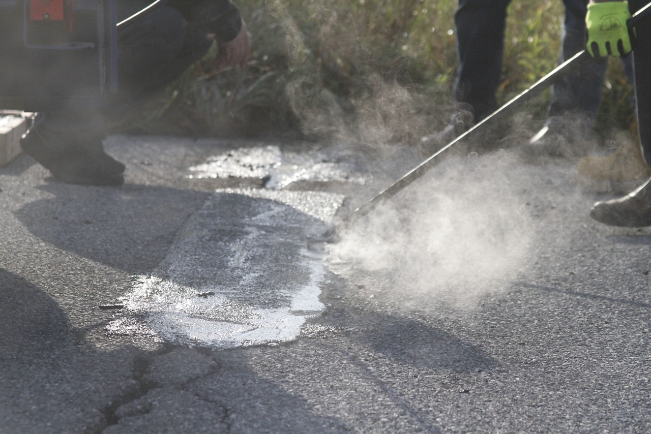 Hot Pour Mastics patch being applied to roadway.