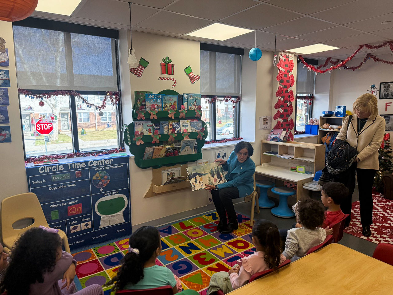 DHS Secretary Val Arkoosh reads a book to a classroom of children 