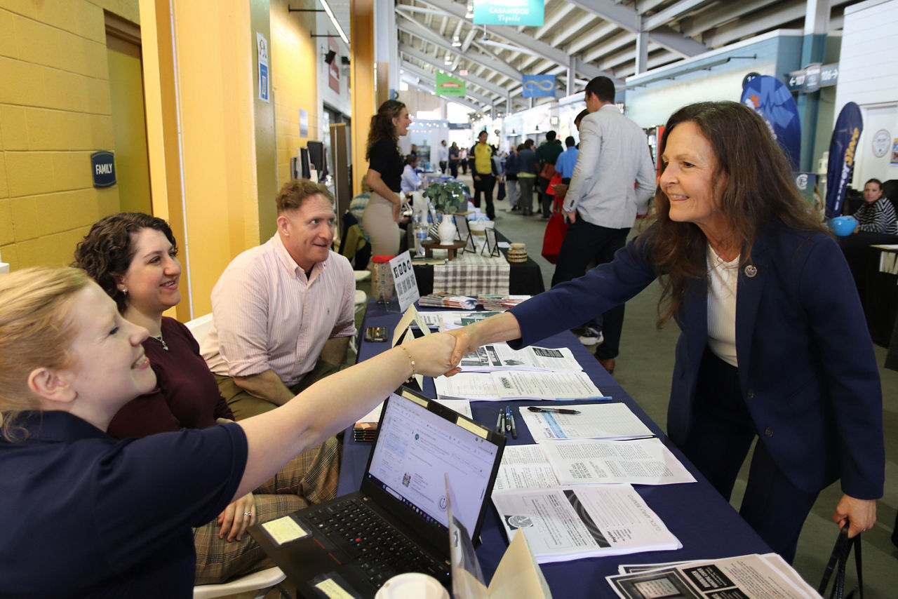 Nancy A. Walker, Secretary of Labor and Industry shakes hands with local businesses at job fair in Chester, PA.