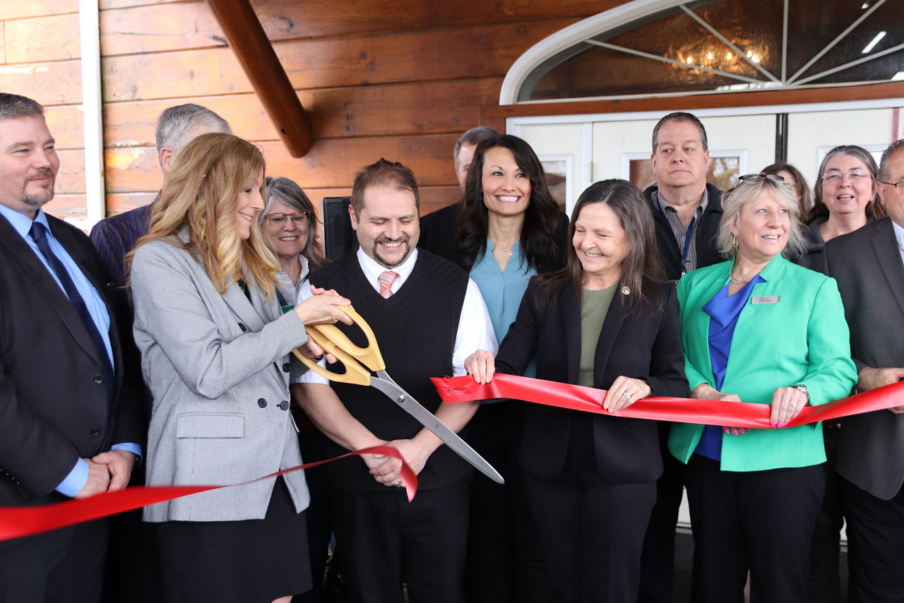 L and I Secretary Nancy A. Walker and others cut a red ribbon with large gold scissors, celebrating the launch of the newest mobile PA CareerLink® unit in Kersey, PA. 