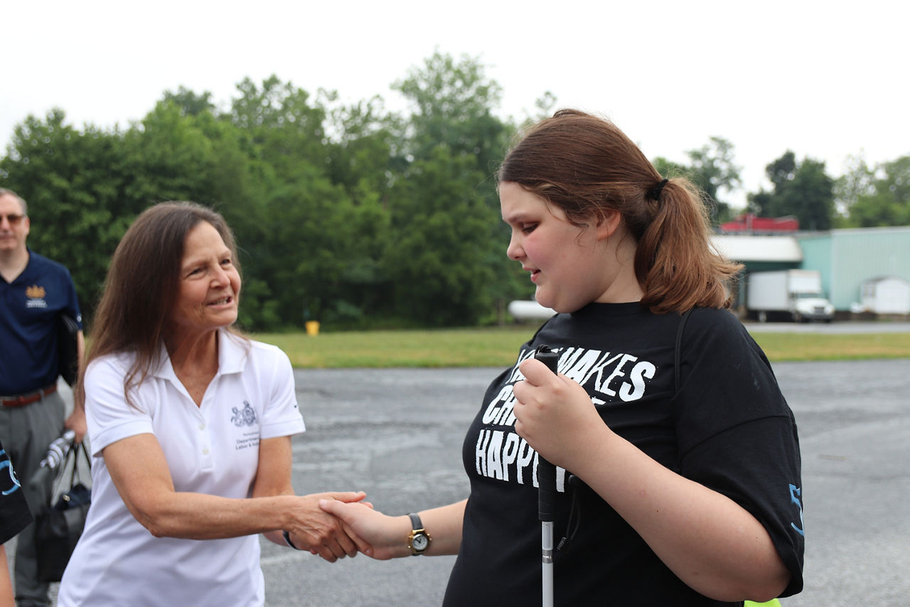 Department of Labor and Industry Secretary Nancy A. Walker shakes hands with high school student at MY Work event in Perry County.