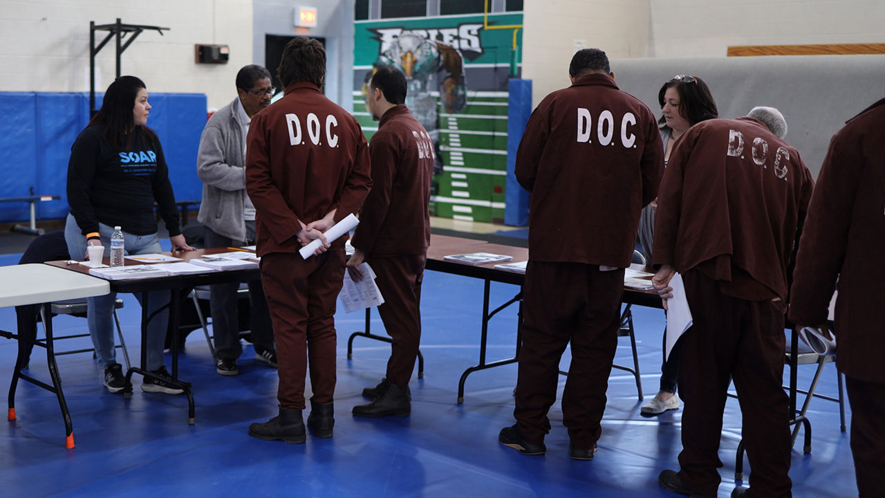 Inmates speak to attendees at a reentry job fair