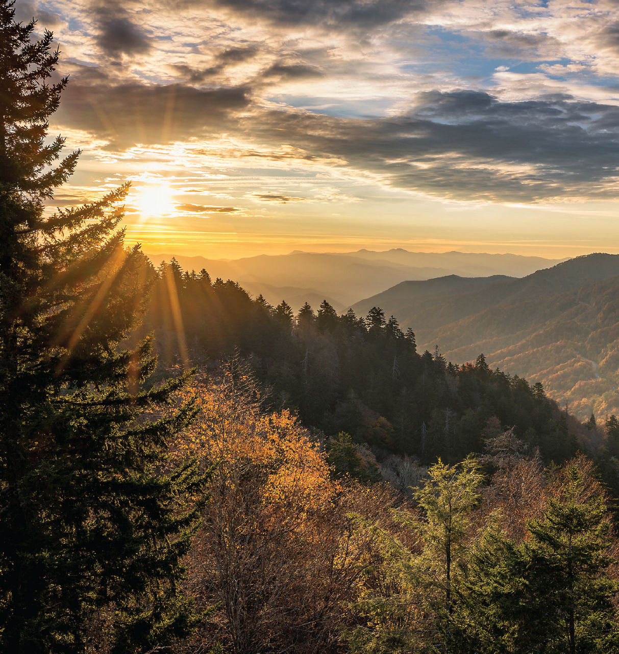 The sun sets over Tennessee mountains and wilderness.