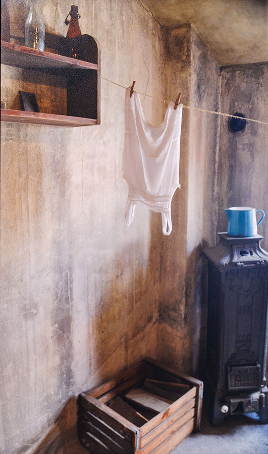 interior of room, white shirt hangs from a clothesline