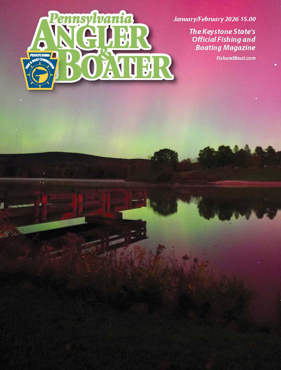Cover page of the January/February 2026 edition of Angler & Boater Magazine featuring a dock along a lake at night with pink and green northern lights in the sky.