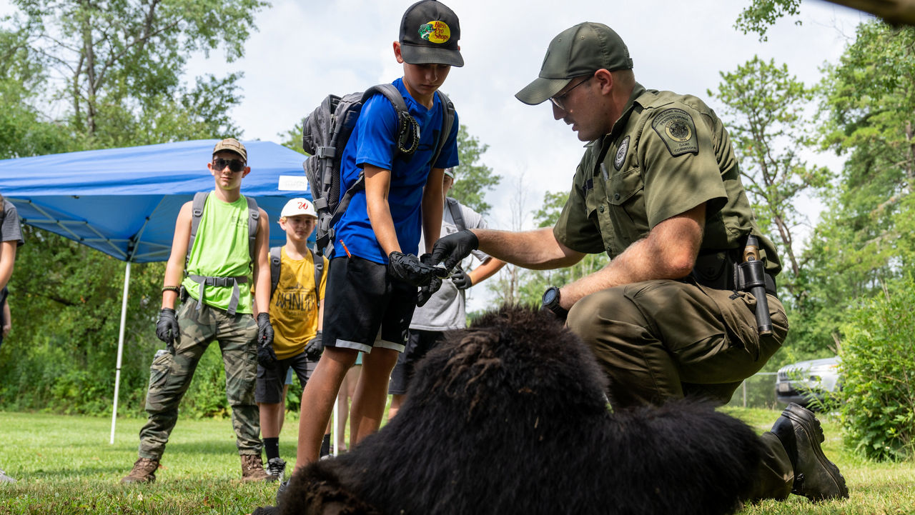 junior game warden with bear
