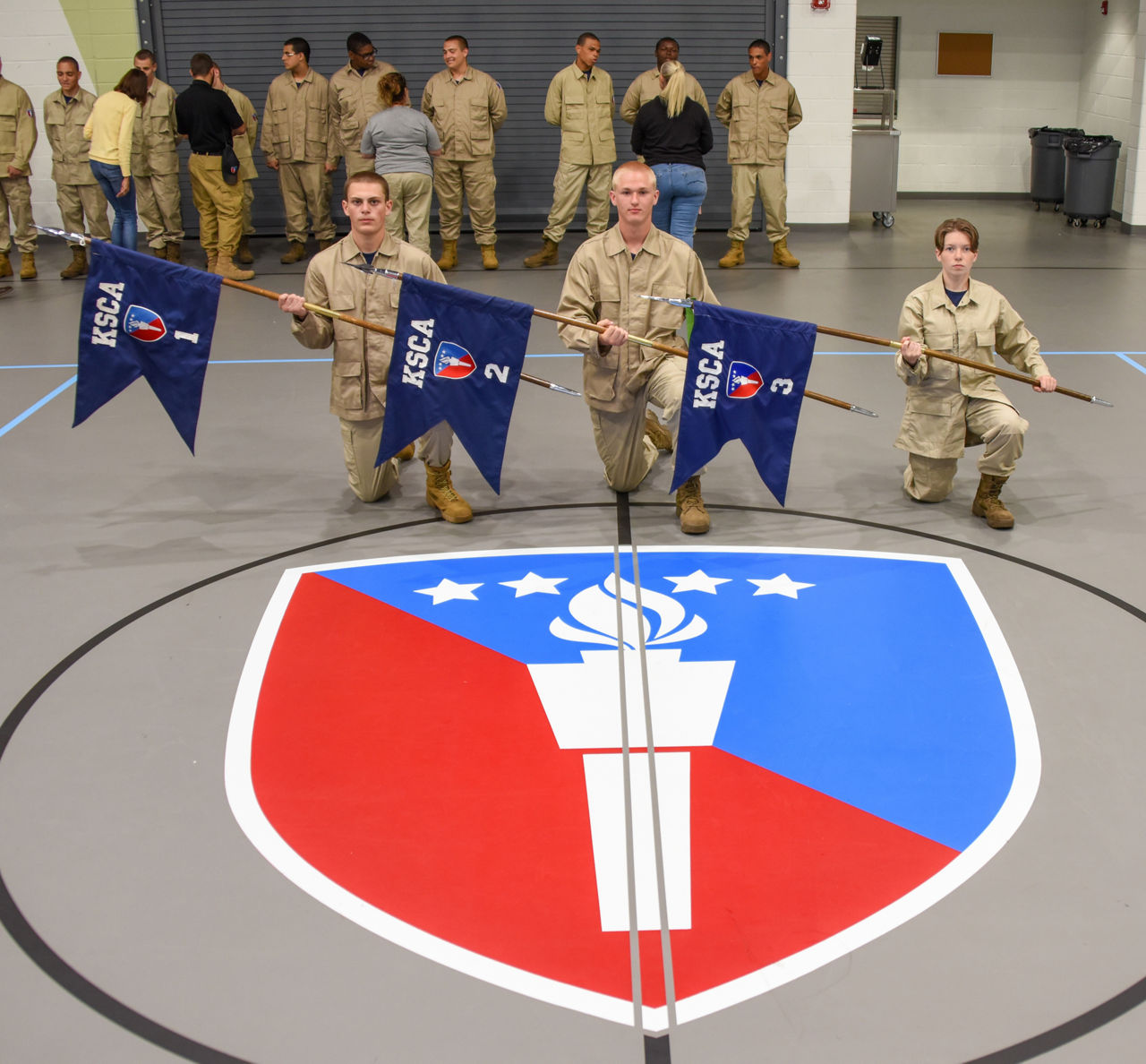 Keystone Challenge Academy Cadets Kneeling in front of the academy logo.