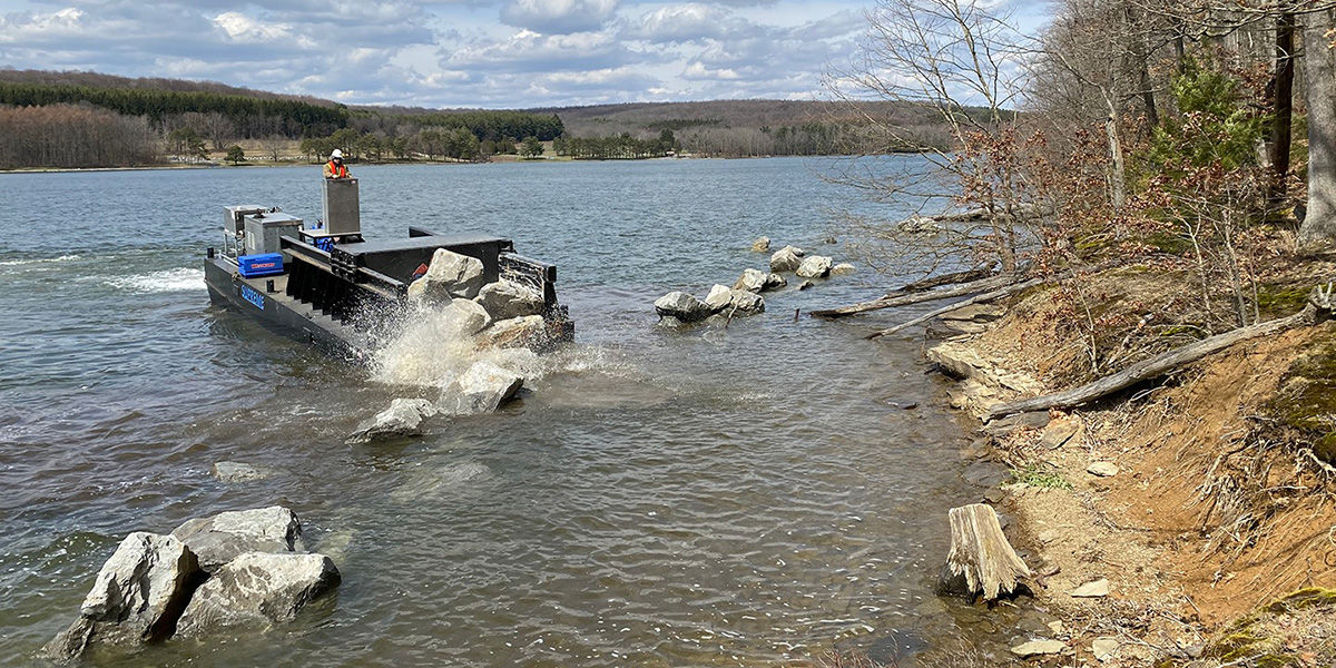 PFBC Rock barge placing large rocks for habitat improvement along the shoreline of Raystown Lake