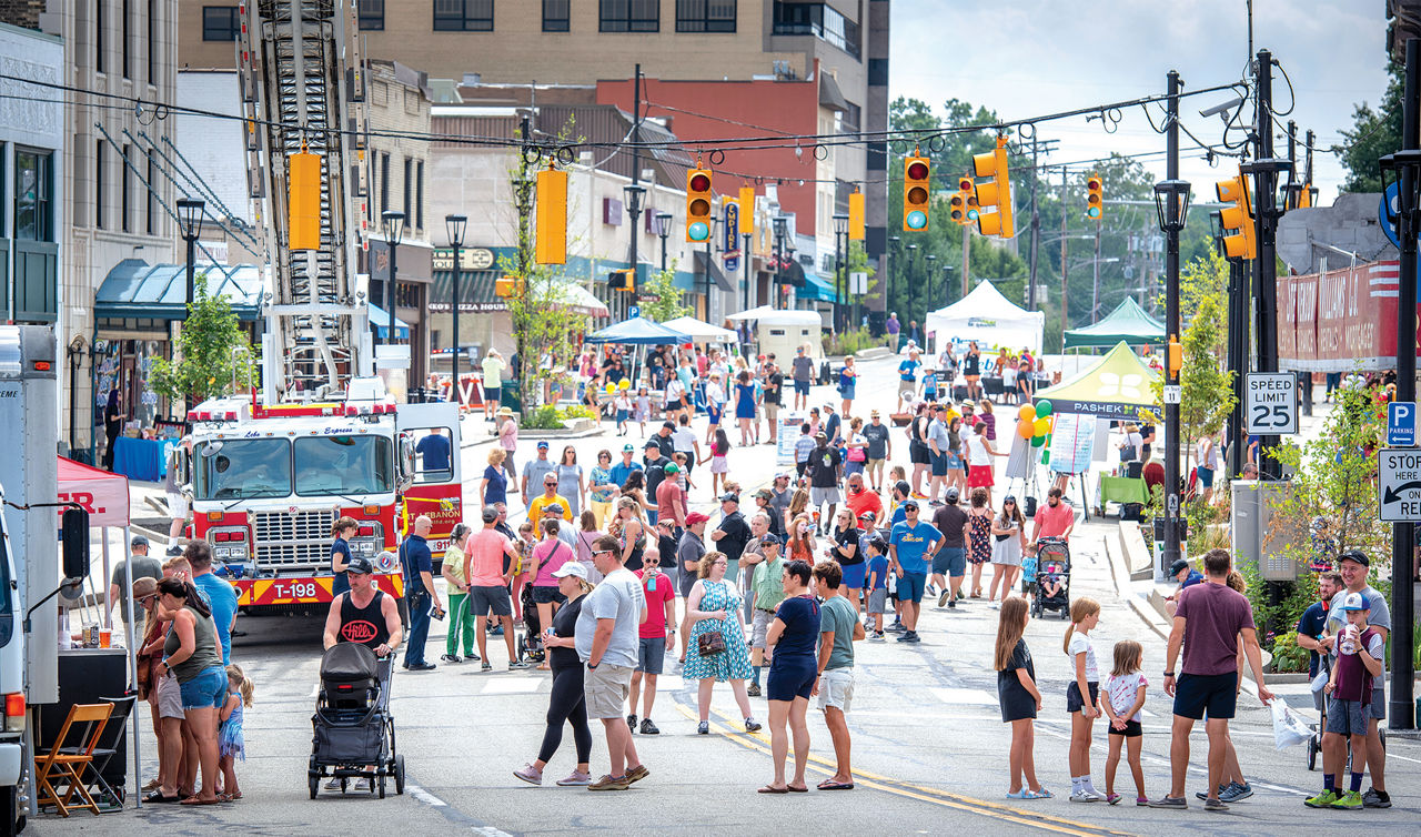 A crowd explore a colorful arts and culure festival on a closed-off street in downtown Lebanon, PA.