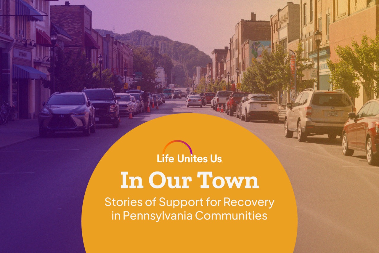 Photography of Main Street in Ambridge, Pennsylvania with Life Unites Us logo and copy that reads as follows: In Our Town, Stories of Support for Recovery in Pennsylvania Communities 