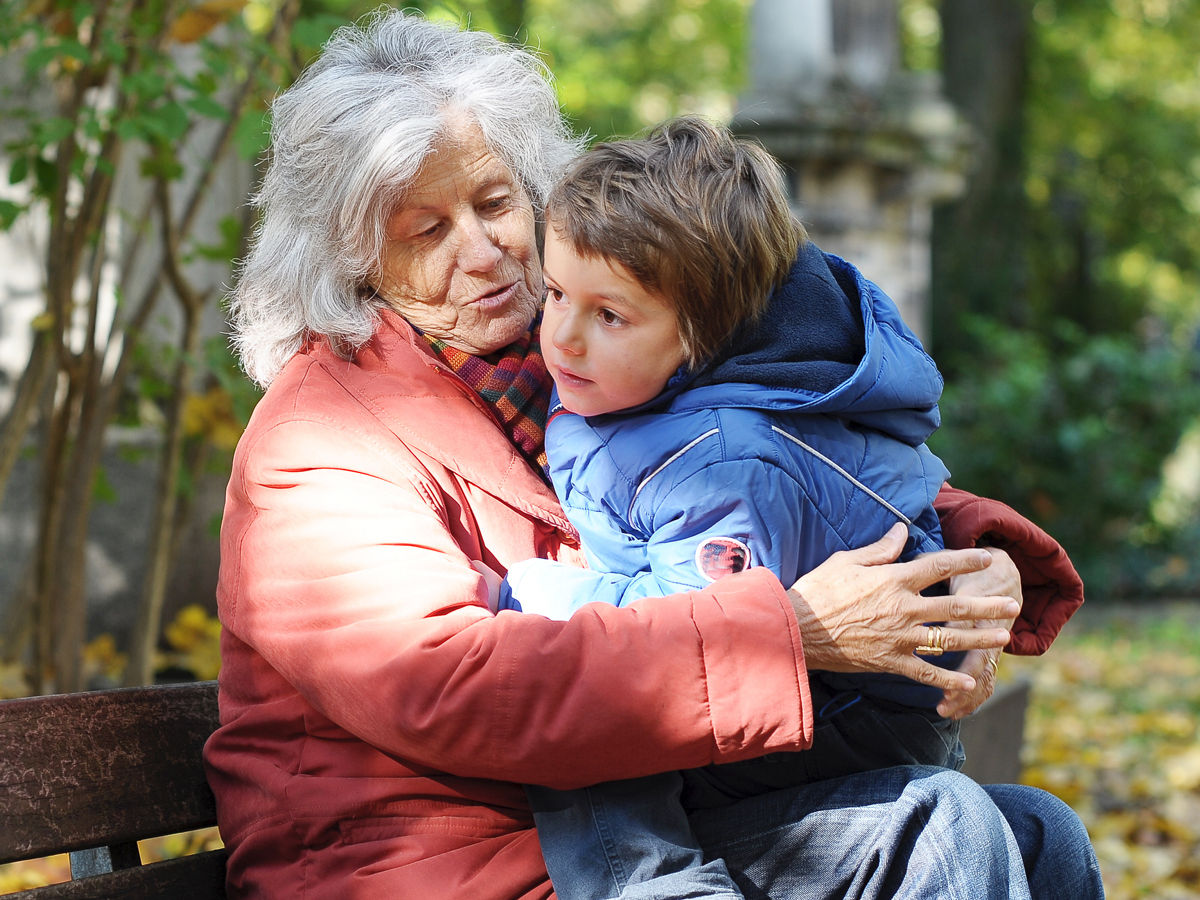 Grandmother holding young boy on her lap