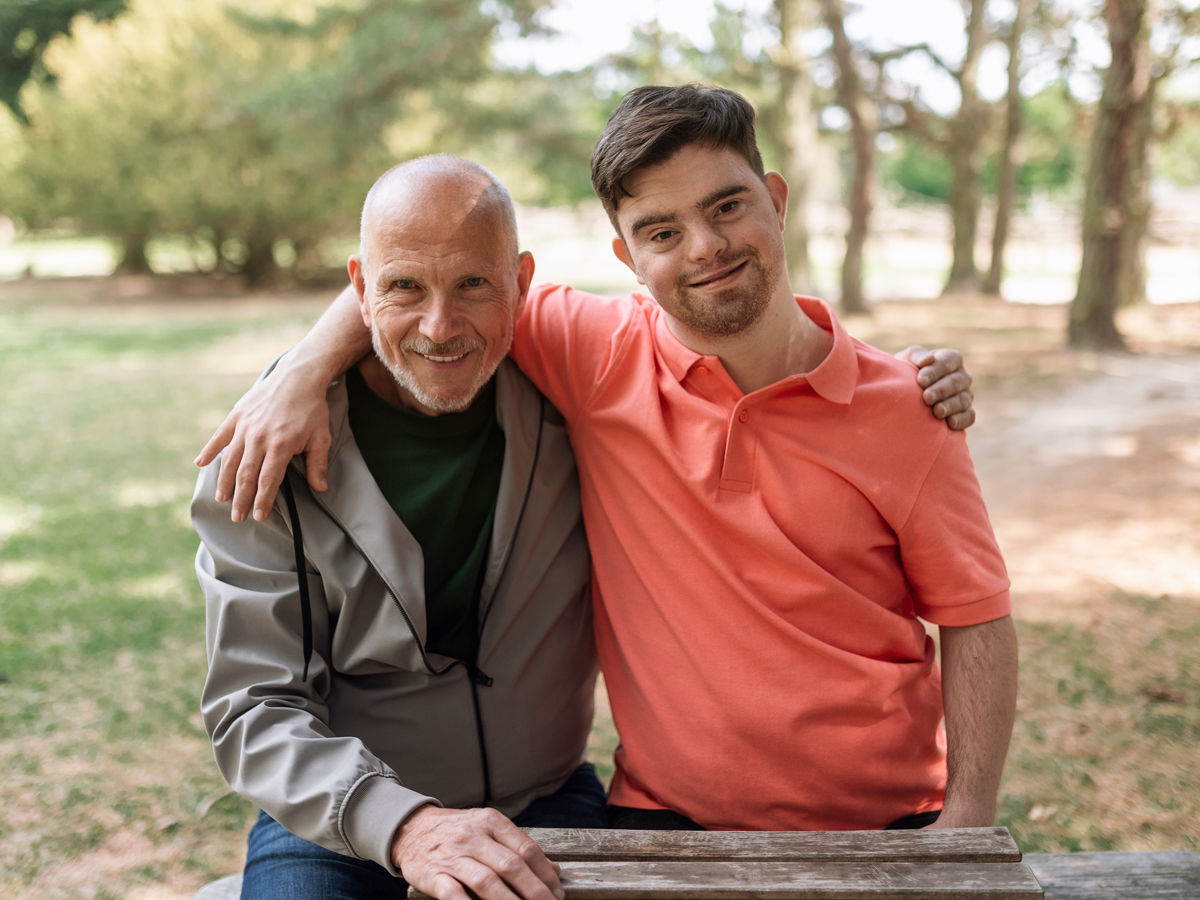 Young man with Downs Syndrome with his father
