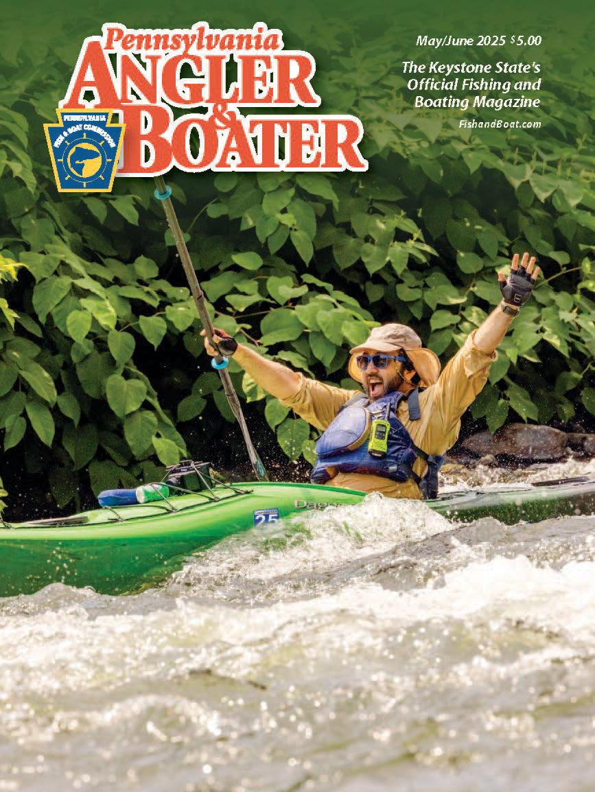 Man wearing a life jacket and excitedly putting his arms in the air as he kayaks down rapids of the Schuylkill River