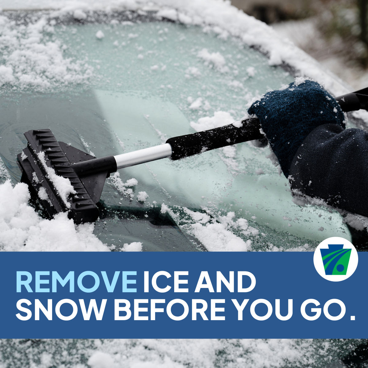 Photo of a person removing snow from their windshield