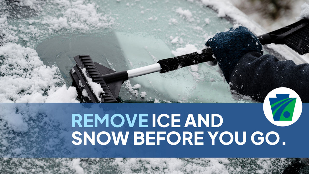 Photo of a person removing snow from their windshield