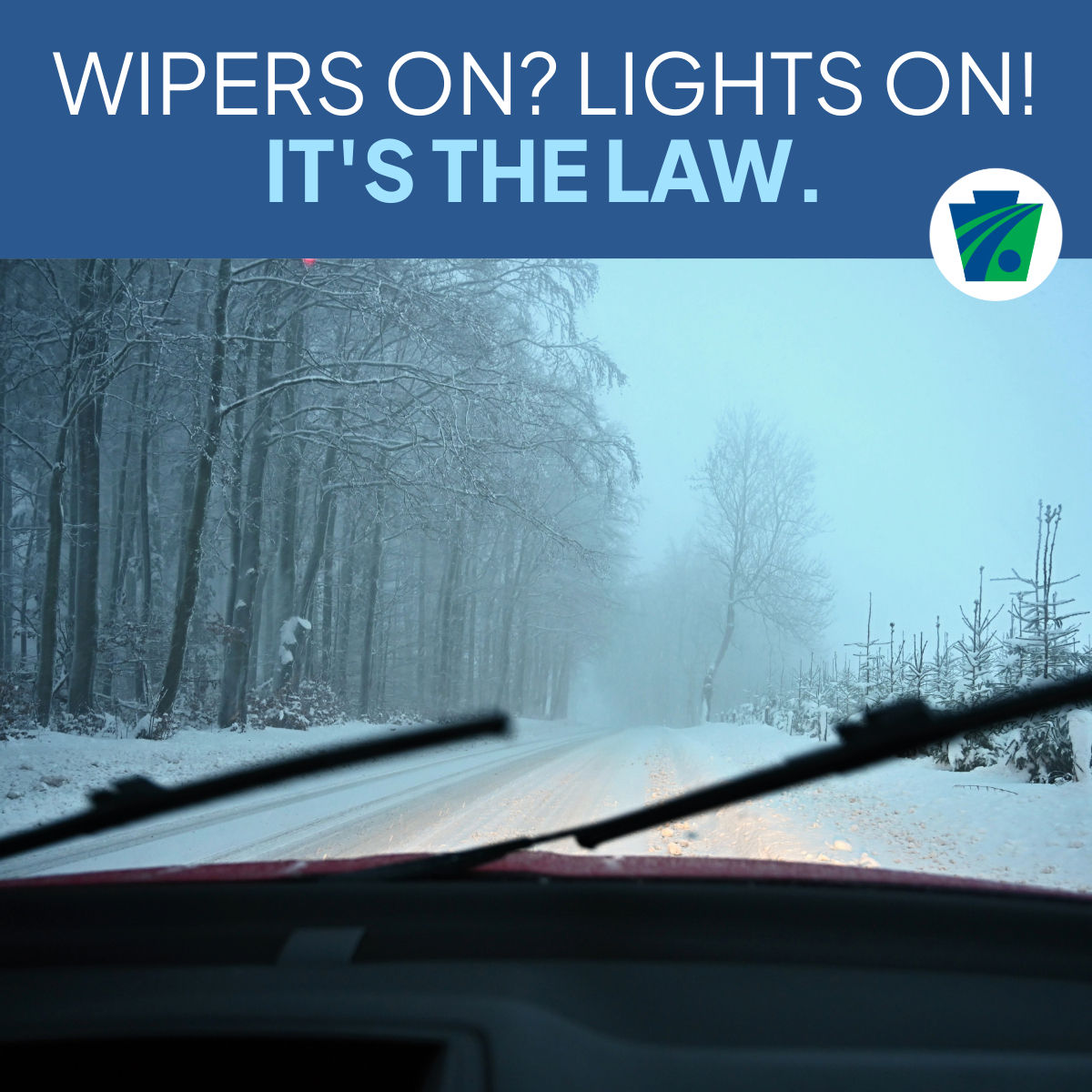  Photo of a snow-covered road through a car windshield with the wipers up