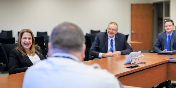 First Lady Lori Shapiro laughs while sitting at a table full of PEMA leadership.