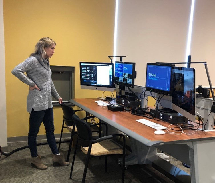 Melissa Hawkins oversees a desk with assistive technology that help individuals who are deaf or hard of hearing