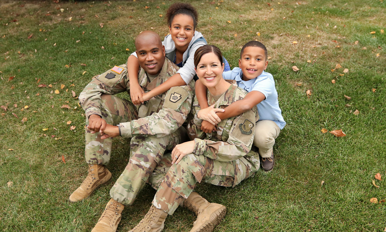 Image a a military man with his son on his shoulders.