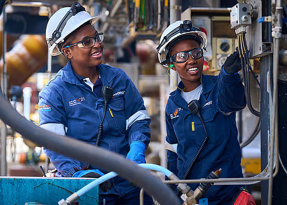 Industrial workers inspecting machinery at plant