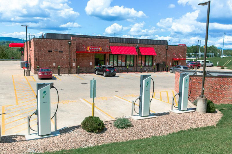 multiple electric vehicle charging stations can be seen in the foreground. In the background, a Sheetz gas station can be seen