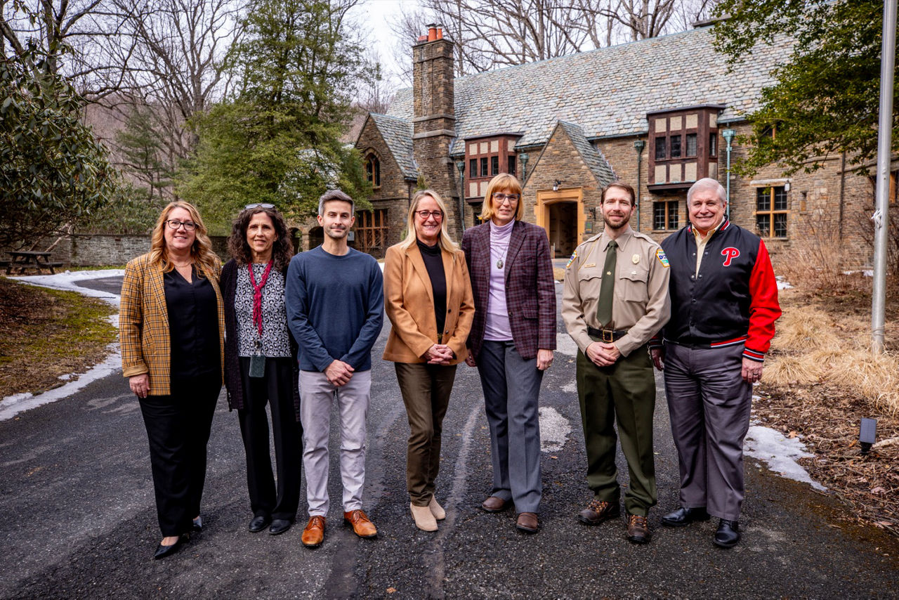 DCNR Secretary Cindy Adams Dunn stands with a group of DCNR staff and partner organizations in front of the upgraded education center at Nolde Forest Environmental Education Center