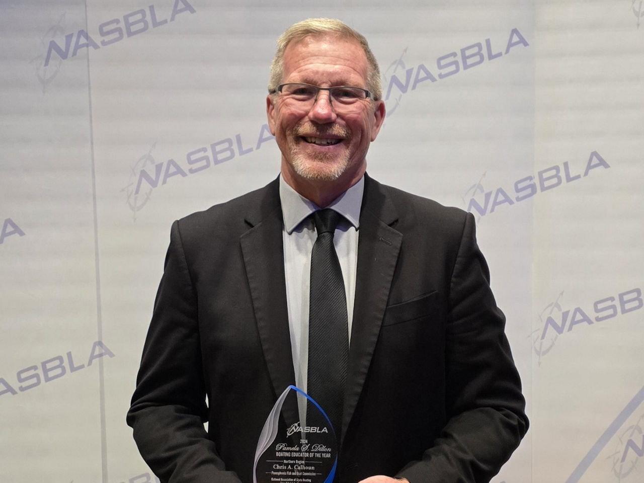 Chris Calhoun pictured holding his award at the NASBLA Annual Conference for 2024 Northern Region Educator of the Year.