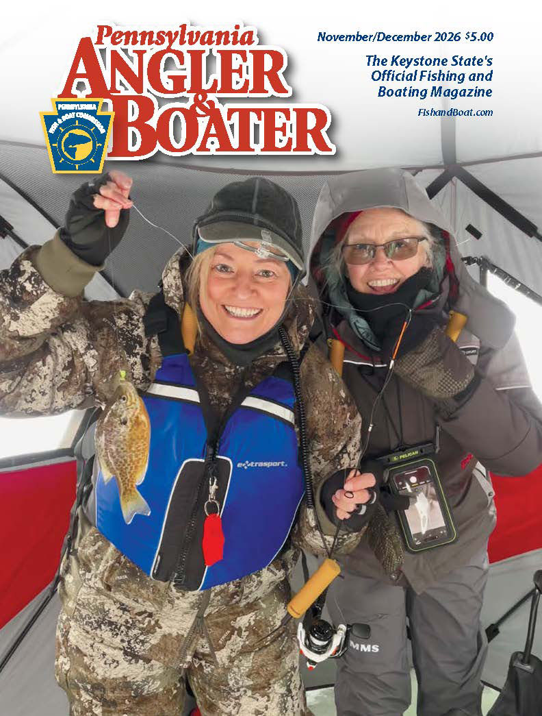 The cover of the November/December Pennsylvania Angler & Boater magazine featuring two women wearing life jackets while ice fishing.