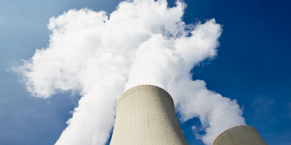 Plumes of smoke from a nuclear power plant tower.