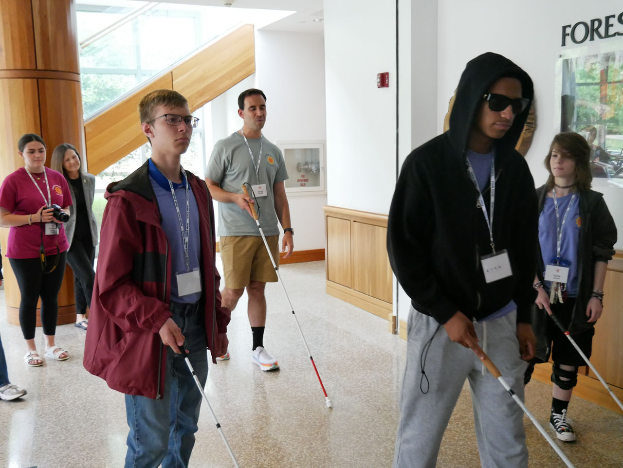 Group of students with visual impairments learn to navigate obstacles using aids with support of OVR staff at summer camp in State College, PA.