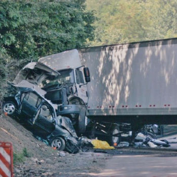Photo of Paul Miller's crashed car on an embankment next to a crashed tractor trailer
