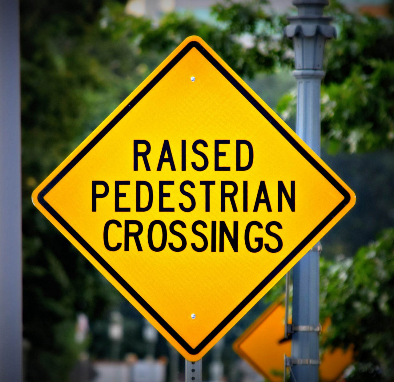 Raised Pedestrian Crossings sign