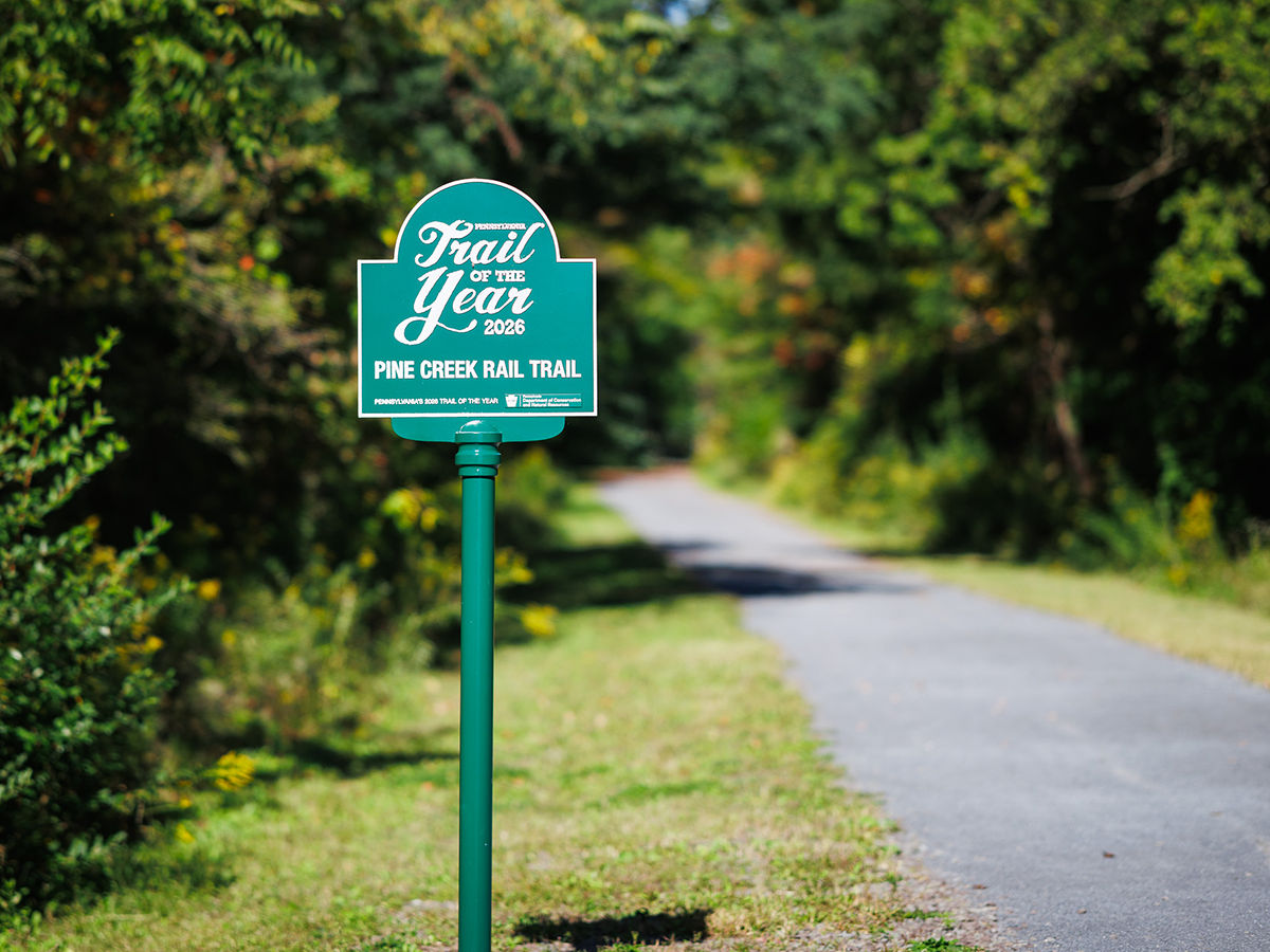 A Trail of the Year sign for the Pine Creek Rail Trail