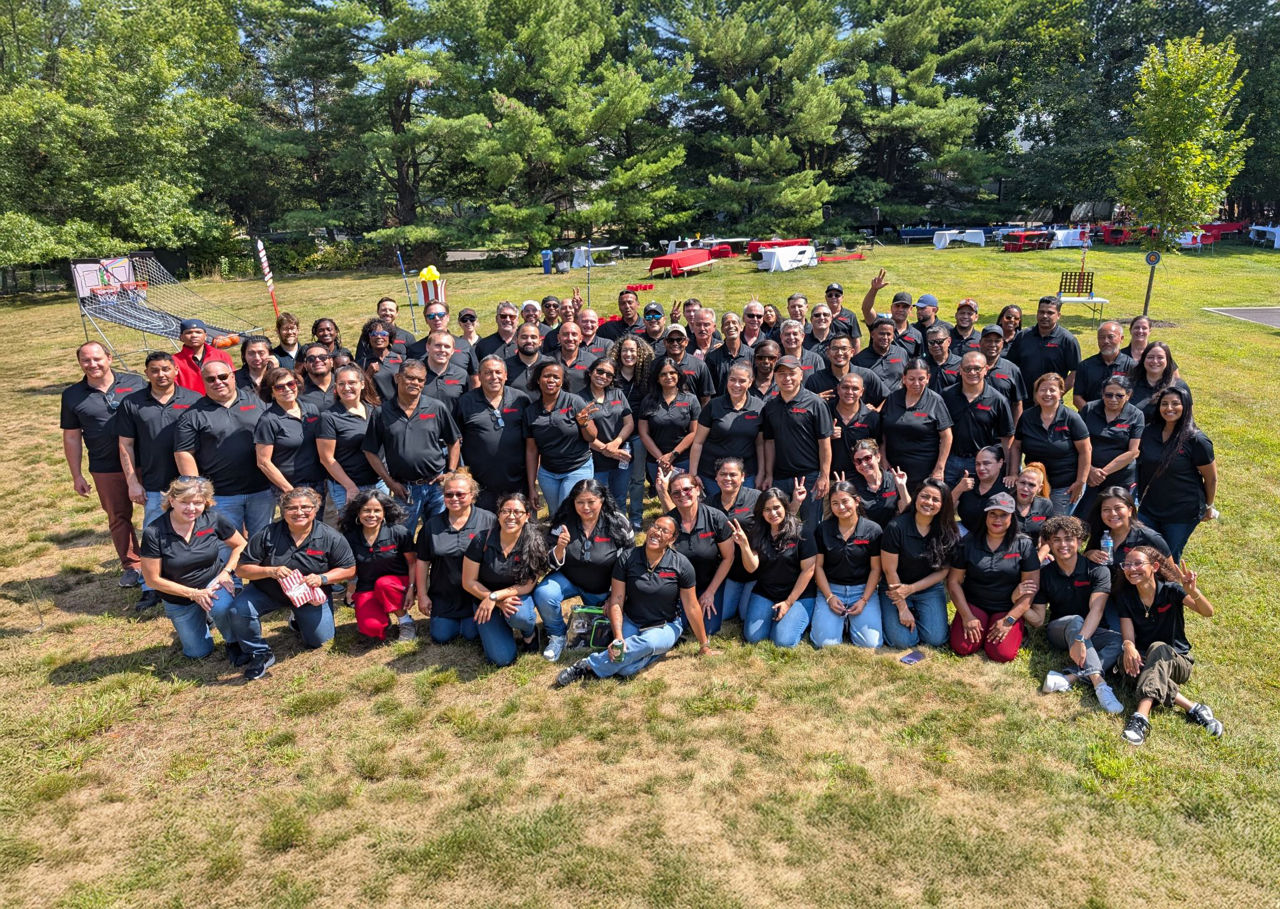 A group photo of employees in a park