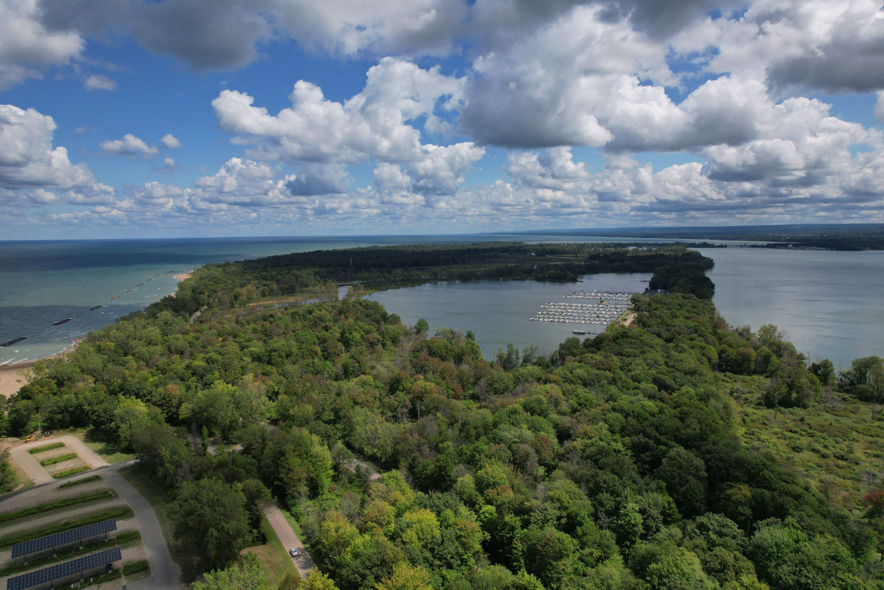 An areal view of a forested curved peninsula