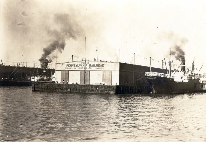 A historical image of a Pennsylvania Railroad dock with cargo ships