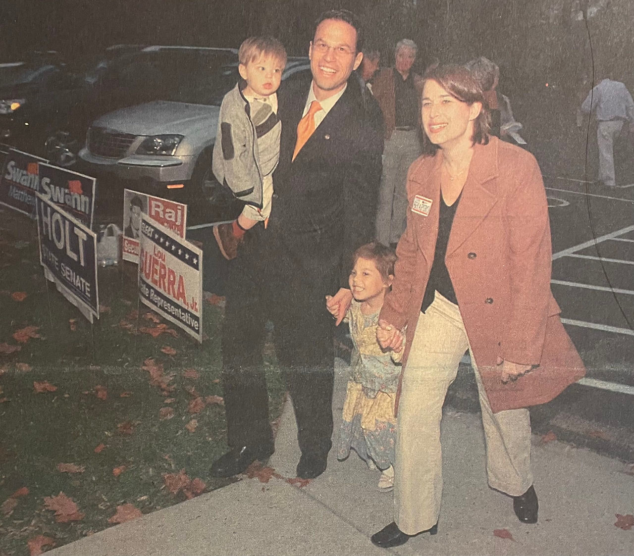 A photo of a newspaper image of Governor Josh Shapiro and First Lady Lori Shapiro walking with their children. 