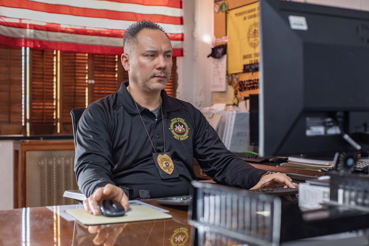 A parole agent using a computer