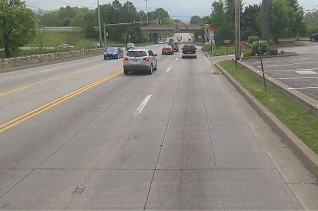 cars driving on concrete roadway