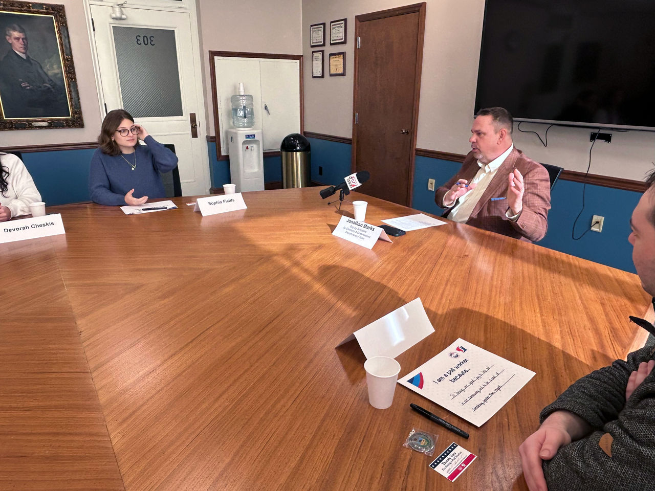 Deputy Secretary for Elections Jonathan Marks speaks during Friday’s poll worker roundtable in the Department’s conference room as current student poll worker Sophia Fields, left, a Susquehanna Township High School senior; and Dylan Kenny, a 10-year poll worker who began volunteering in the role as a Susquehanna Township High School student. The roundtable was held in advance of national Help America Vote Day, which is today (Jan. 27).