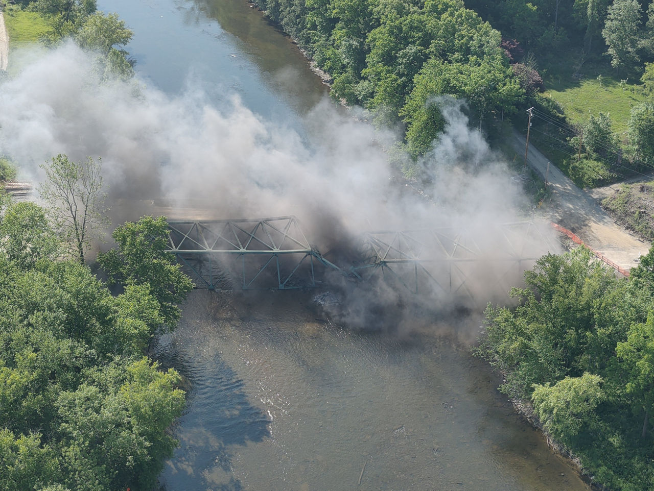 Smoke and dust from controlled  bridge explosion