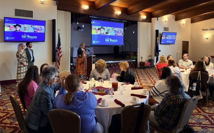 Community gathering with presentation screens