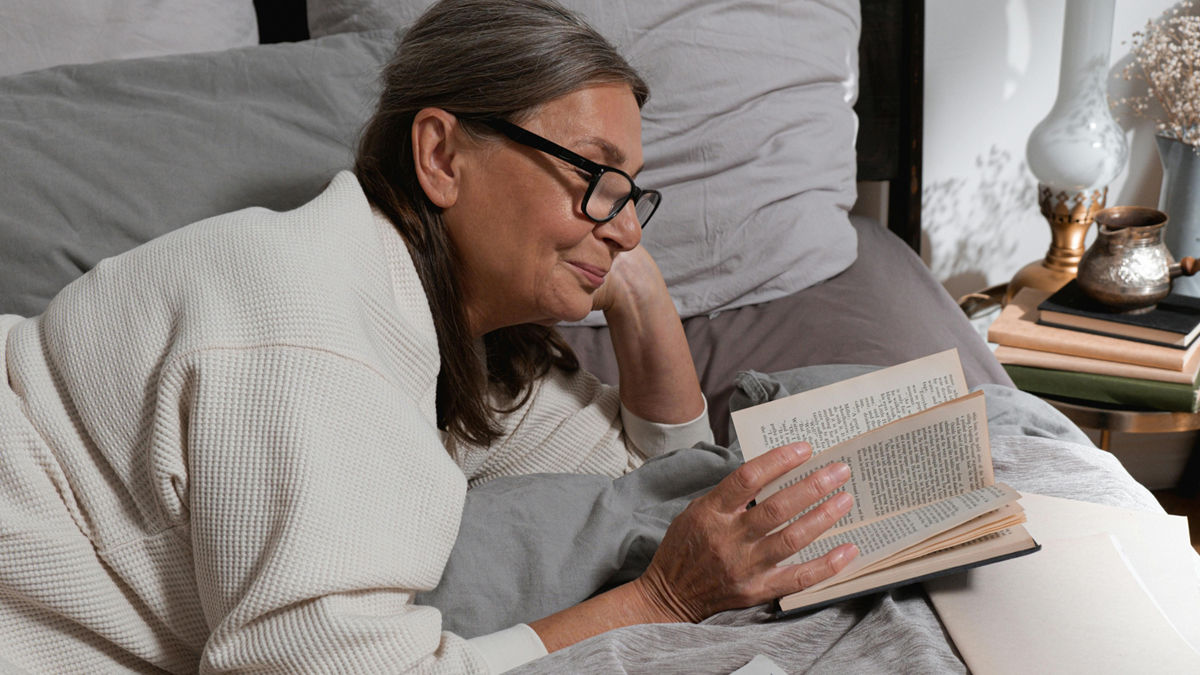 Woman with glasses reading a book