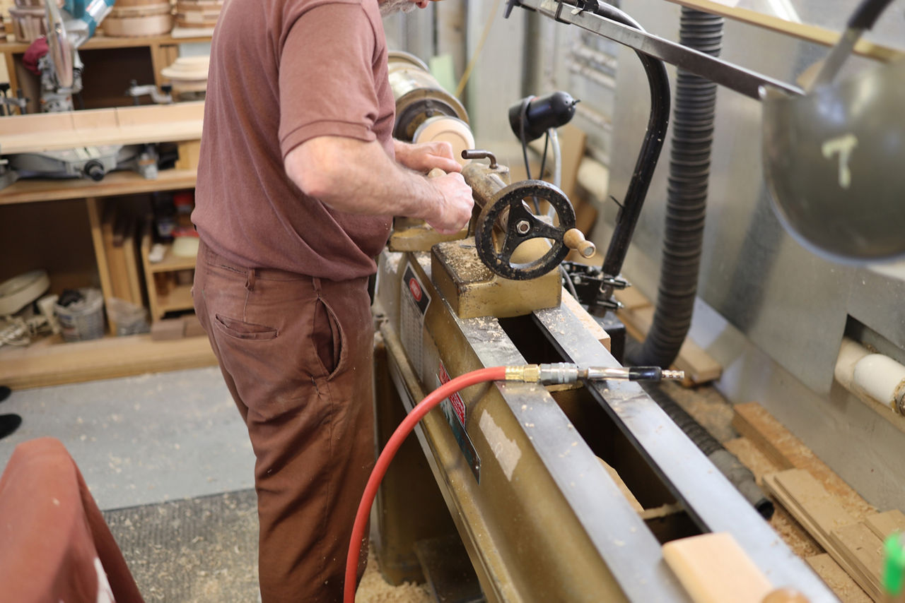 An inmate worker uses a tool for woodworking