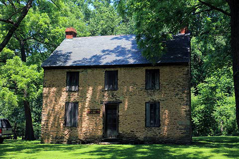 The Long Home photograph shows a two-story brick house with a black and steeply pitched roof.