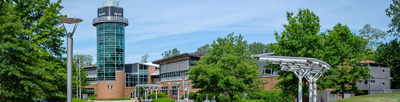 The Tom Ridge Environmental Center surrounded by green trees on a sunny day