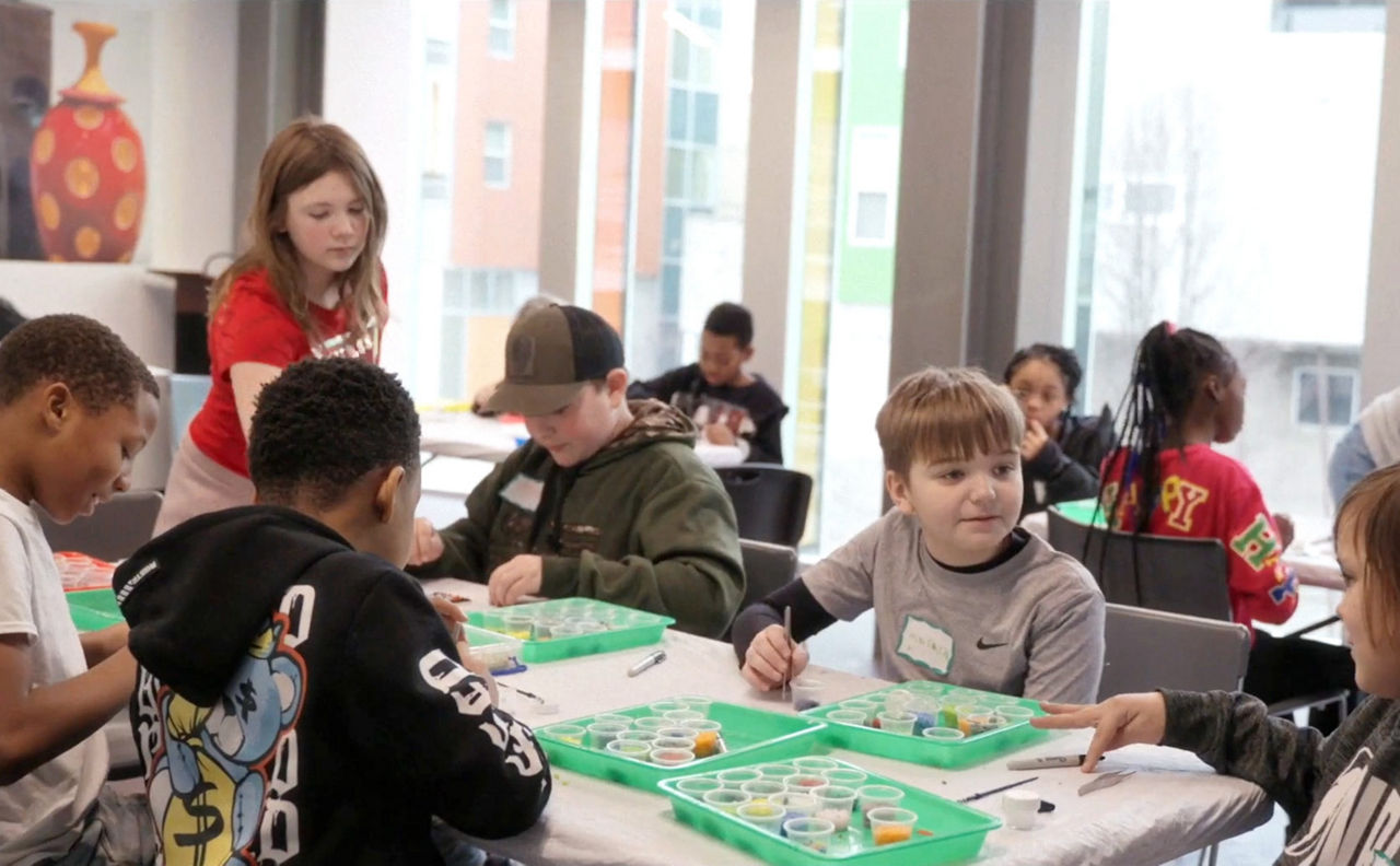 Student artists creating art at a workshop