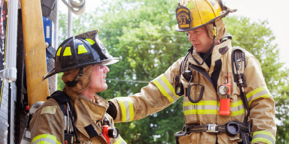 Image of a firefighter lending another firefighter support